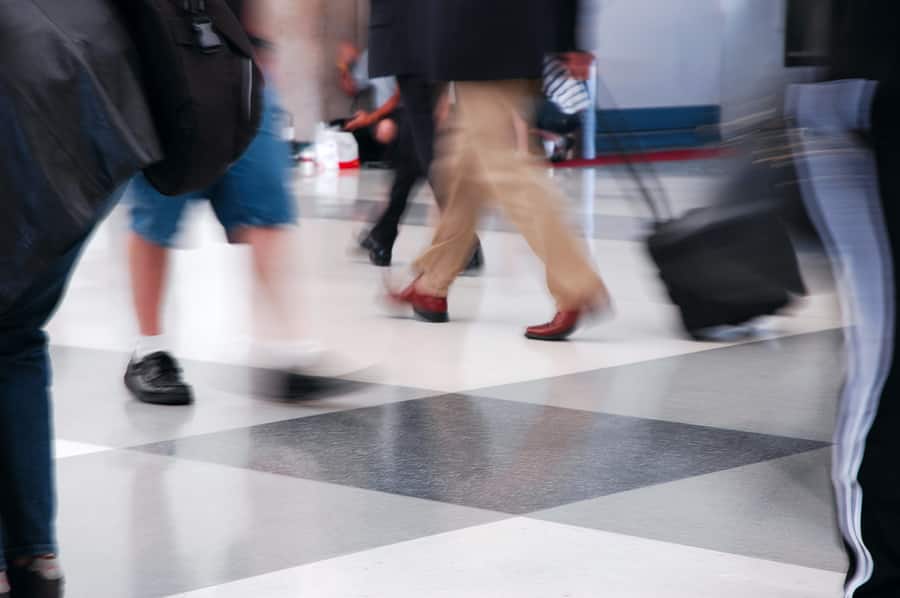 Travelers rushing through an airport