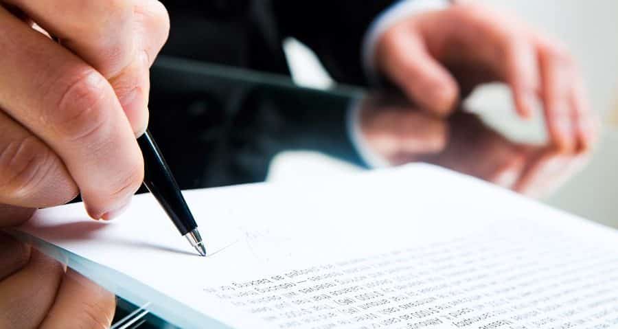 signing lawyer business document e1526060804654